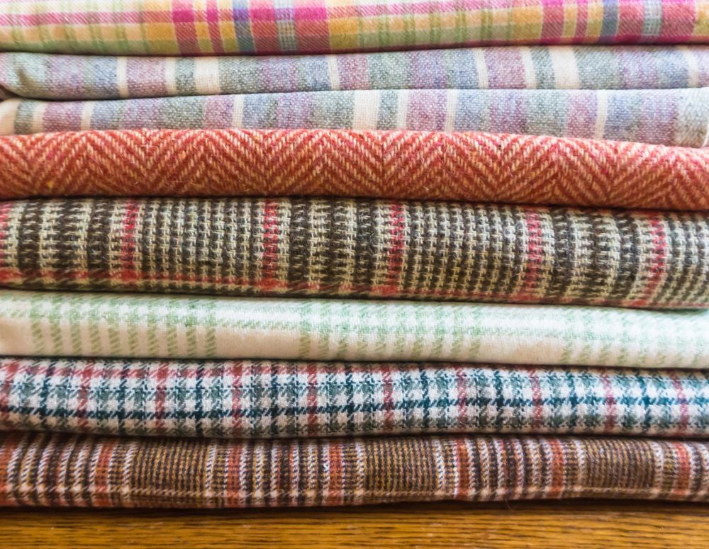Colourful spools of thread arranged on a work table